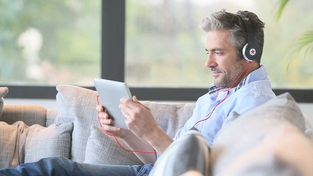 Mature man watching movie on tablet