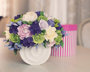 Rose flower bouquet and gift box on wooden table