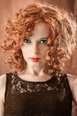 Fototapeta premium Portrait of beautiful woman with long curly red.