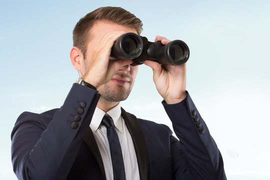 Young businessman with a binocular