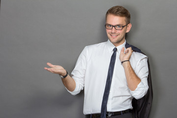 A handsome young businessman wearing glasses and smiling. Vertic