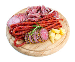 smoked salami, sausages and proschiutto isolated on white