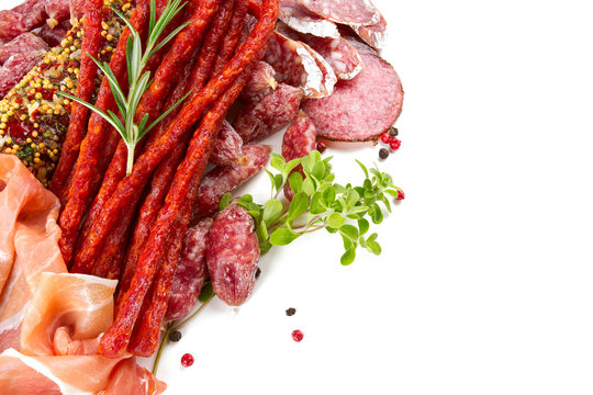 smoked salami, sausages and proschiutto isolated on white