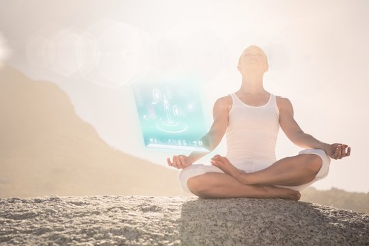 Composite image of blonde woman sitting in lotus pose on beach