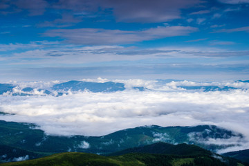 Clouds in the morning rise over the mountains in the Carpathians