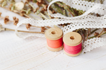 Sewing kit with flowers on a wooden background