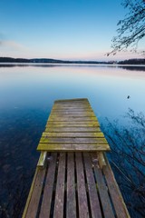 Lake landscape with small old wooden pier 