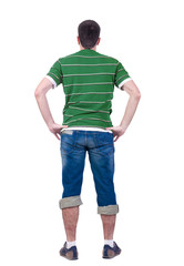 Obraz premium young man looks at white background. rear view.