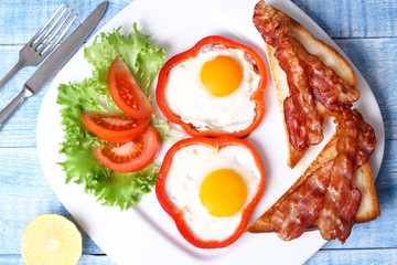 Breakfast fried eggs, bacon, tomatoes and lettuce