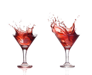 Red wine or alcohol cocktail splashing out of glass