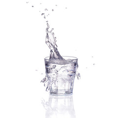 Fresh water splash in a glass isolated on white background