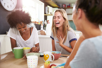 Three Female Friends Enjoying Breakfast At Home Together - Powered by Adobe