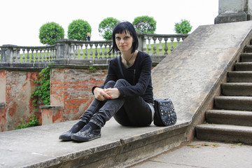 Goth girl on the top of ancient Wall