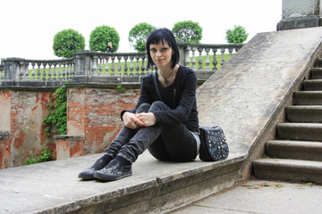 Goth girl on the top of ancient Wall