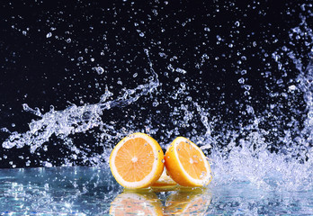 Fototapeta na wymiar Macro water splash on lemon. Water drops splash