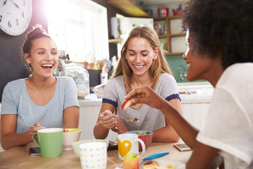 Three Female Friends Enjoying Breakfast At Home Together