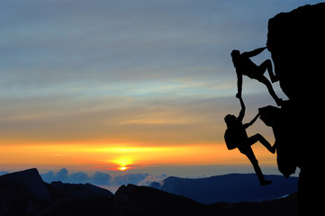 Teamwork of two people man and girl on mountain