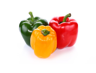 colored peppers over white background