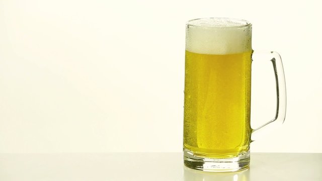 pouring of fresh beer on white