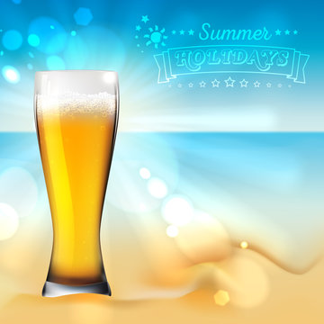 Glass of beer on the sand. Summer landscape