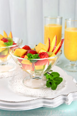Fruit salad with mint and orange juice in glassware