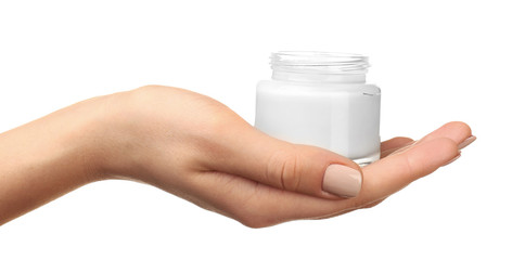 Female hand holding jar of cream isolated on white