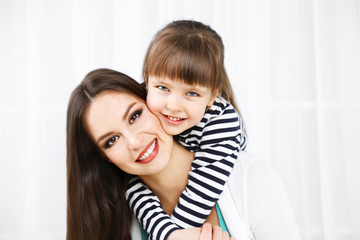 Two girls smiling on home interior background