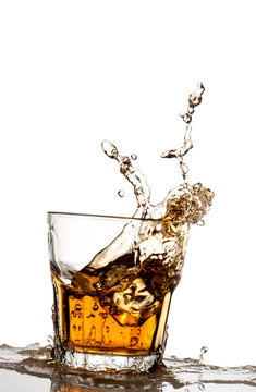 Isolated shot of whiskey with splash on white