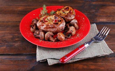 Baked potatoes with mushrooms on pate on wooden table