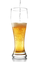Pouring beer into glass isolated on white