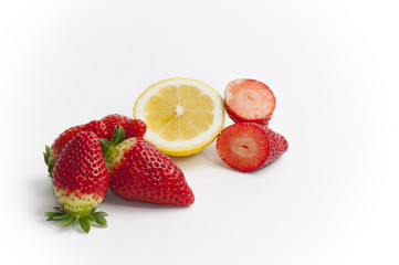 stil life of organic strawberries and lemon all cut
