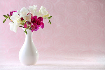 Beautiful spring flowers on pink background