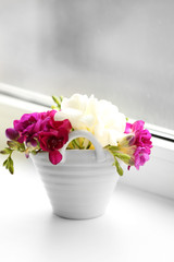 Beautiful spring flowers on windowsill background
