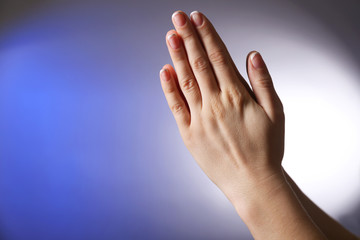 Woman praying on bright background