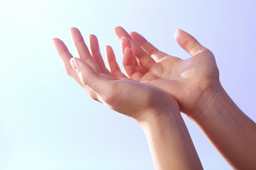 Woman praying on bright background