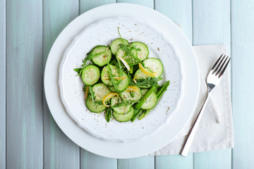 Green salad with cucumber, arugula and lemon peel