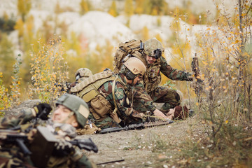 Fototapeta premium Rangers team assisting wounded man in the forest