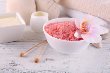 Spa still life with color sea salt on wooden table, closeup
