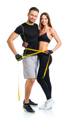 Happy athletic couple - man and woman with measuring tape on the