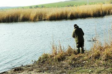 Man fishing on riverside