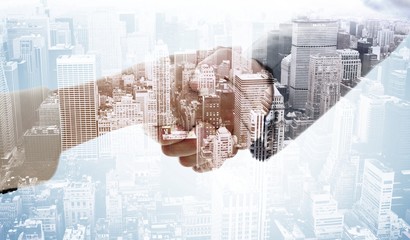 Composite image of business handshake