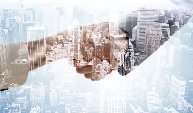 Composite image of business handshake - Powered by Adobe