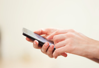 Close up of a woman using mobile smart phone