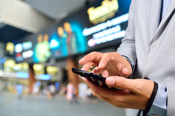 Handsome young man in shopping mall using mobile phone