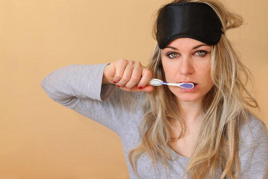 Young women brushing her teeth