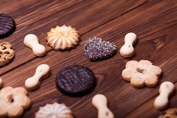 Various cookies on the wooden table