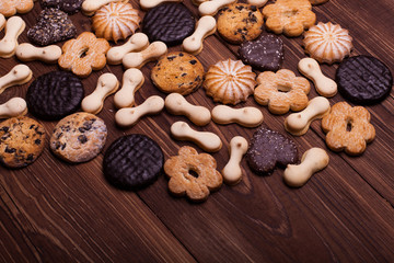Various cookies on the wooden table