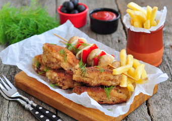 fried chicken wings with red sauce and French fries  potatoes