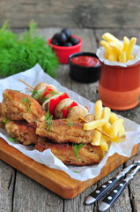 fried chicken wings with red sauce and French fries  potatoes
