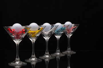 Five glasses of champagne and golf tees